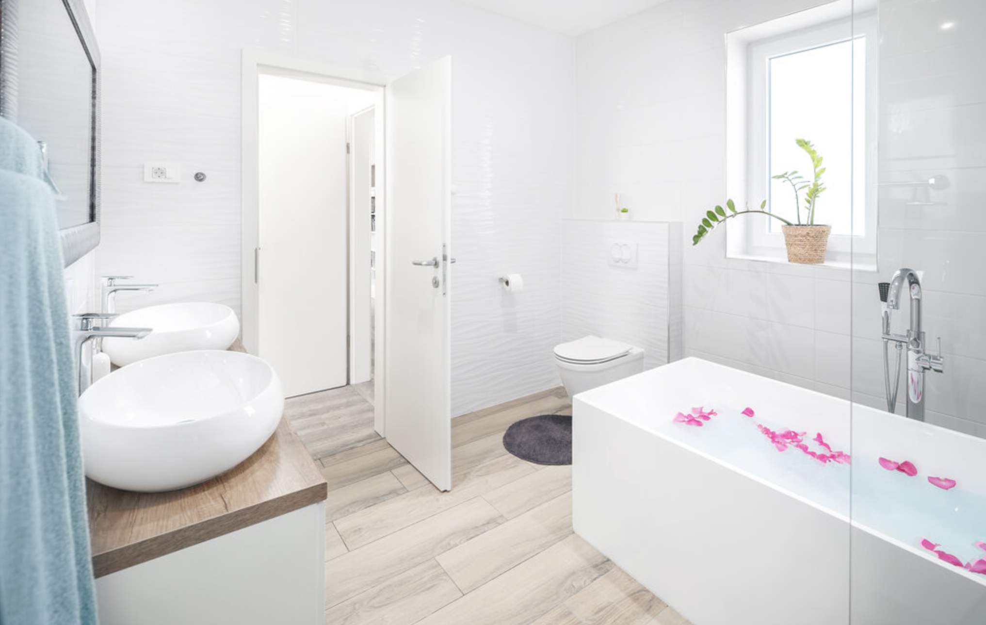 Villa Mia bathroom with bathtub, vanity and natural light