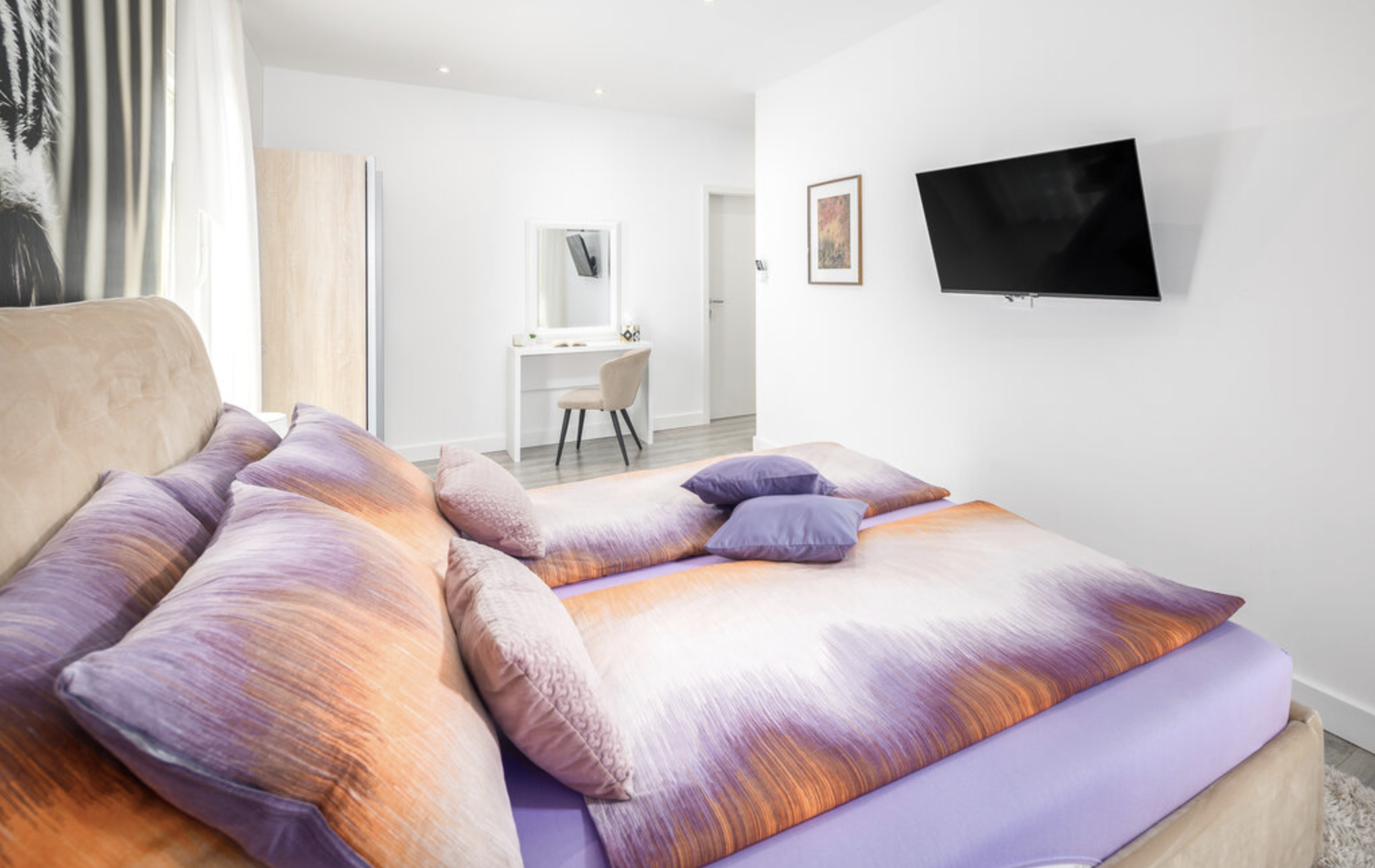 Villa Mia lavender bedroom with desk and wall-mounted TV
