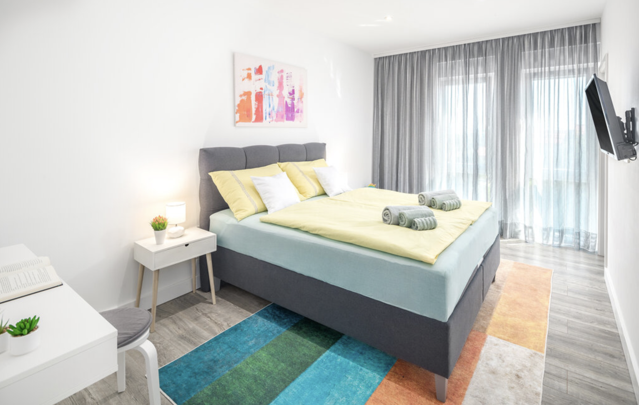 Villa Mia bedroom with yellow bedding and balcony doors
